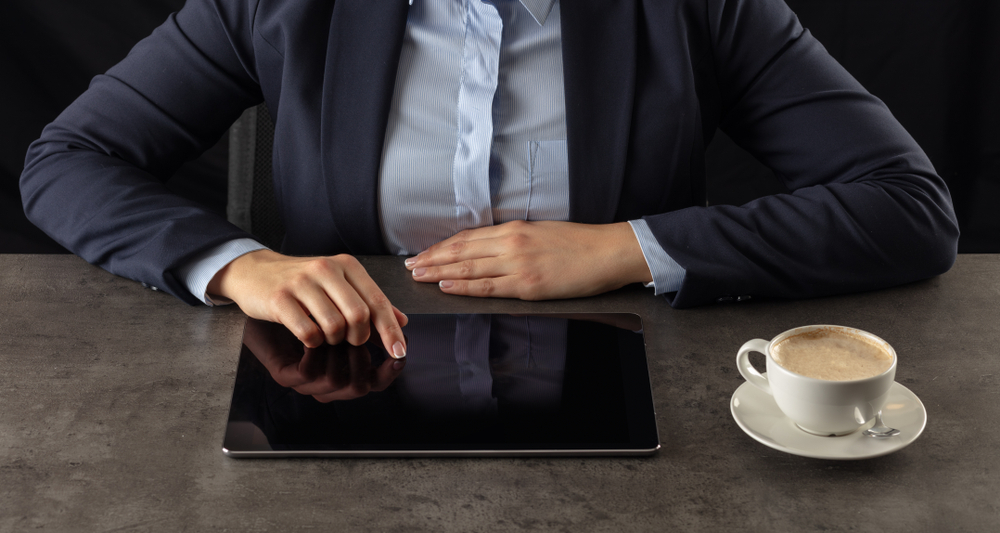 A woman interacting with a tablet computer